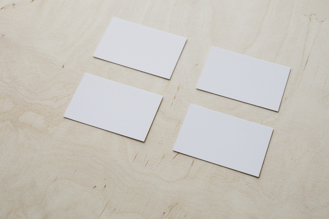 4 Plain Business cards on wooden tabletop